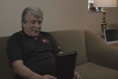 JP Roofing owner sits at computer