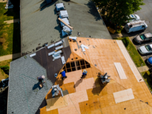 Pittsburgh JP Roofing: men working on shingling a roof